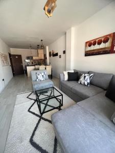a living room with a couch and a chair at The Tower - Lovely apartment @ Bansko Royal Towers in Bansko