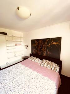 a bedroom with a bed with a large headboard at Villa Golda in Petrovac na Moru