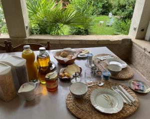 a table with plates of food on top of it at Maison d'Hotes Le Val d'Aleth in Alet-les-Bains