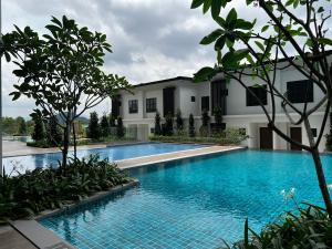 a swimming pool in front of a building at Ipoh Peaceful Onsen 1 BR Lost World Tambun in Tambun