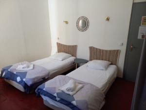 Voodi või voodid majutusasutuse Hôtel Du Cours toas