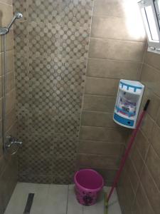 La salle de bains est pourvue d'une douche avec un seau rose. dans l'établissement Studio Apartment By The Beach, à Tanger