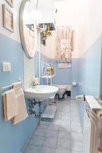 ローマにあるGarden Houseの青と白のバスルーム(シンク、鏡付)