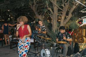 a group of people singing and playing drums at Chu Hotel in Danang