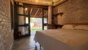 a bedroom with a bed and a large window at Nongu Home in Trincomalee