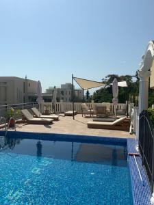 a swimming pool with chaise lounge chairs at Villa Apartmani Anja in Dobra Voda