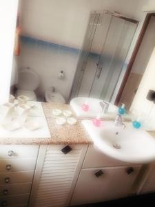 a bathroom with two sinks and a toilet at B&B Il Giardino Delle Fate in Lecco