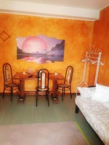 a dining room with a table and chairs and a bed at B&B Il Giardino Delle Fate in Lecco