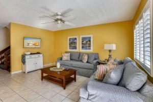 a living room with two couches and a table at Gulfside Villas 6 in Clearwater Beach