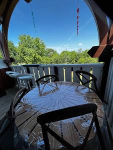 a table and chairs on a balcony with an umbrella at Le Nid du Teich in Le Teich +11 photos