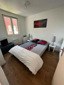 a bedroom with a large bed in a room at Le Nid du Teich in Le Teich