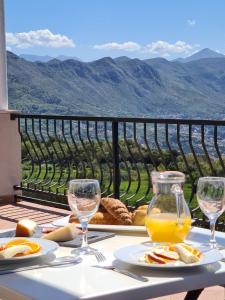 a table with plates of food and glasses of orange juice at Villa Sunrise in Gornji Brgat