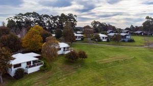 an aerial view of a yard with houses and trees at Karri Mia Chalets and Studios in Denmark