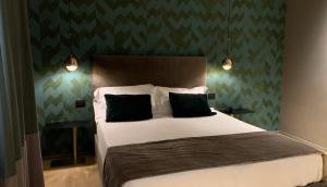 a bedroom with a bed with black and green wallpaper at Re Sale Boutique Hotel in Trapani