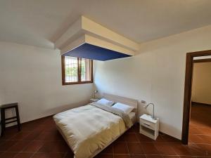 a bedroom with a bed with a blue ceiling at Casa Mario Spacious Garden Apartments, Lake Como in Domaso