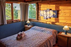 a bedroom with a bed with shoes on it at Piedramora in Villa Giardino