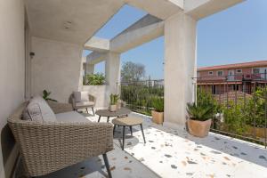 an outdoor patio with wicker chairs and tables at Agave Boutique Hotel in Laganas