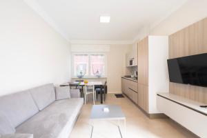 a living room with a couch and a table at Borgo alla Pieve Apartments by Garda Facilities in Manerba del Garda