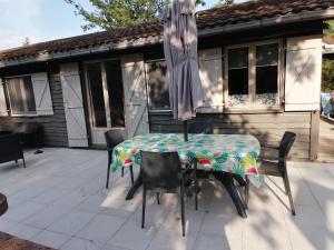 een tafel en stoelen met een parasol op een patio bij DURBUY Kleine familiechalet EDELWEISS 4 à 5 pers in Durbuy