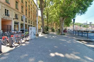 un groupe de vélos garés sur un trottoir à côté des bâtiments dans l'établissement Appartement cosy, confortable et idéalement situé, à Lyon
