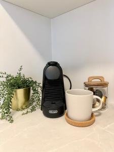 a toaster sitting on a counter next to a cup at Knøsesmauet Apartment in Bergen