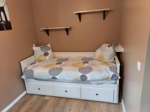 a small bedroom with a bed with pillows at Chaillot 6 in Saintes