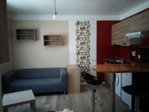a living room with a blue couch and a table at Chaillot 6 in Saintes