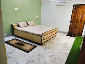 a bedroom with a bed in a room with a door at Yellow Homestay - Modern 2BHK AC stay in Jabalpur