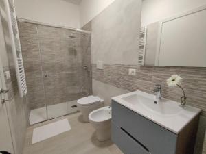 a bathroom with a toilet and a sink and a shower at Sabbia di Mare in Termoli +27 photos