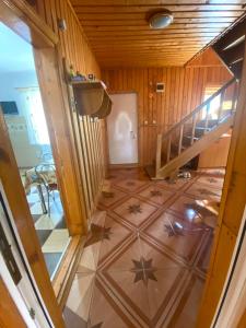 a room with a staircase and a floor with stars on it at Casa de Vacanta Catrinel in Ranca