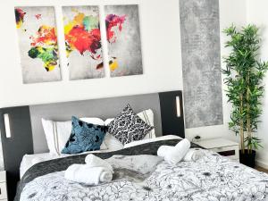 a bedroom with a bed with towels on it at Design apartment Dresden centre - enjoy and relax in Dresden