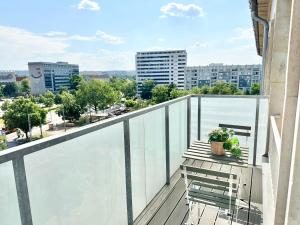 a balcony with a bench and a view of a city at Design apartment Dresden centre - enjoy and relax in Dresden
