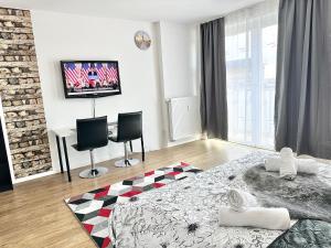 a bedroom with a bed and a tv on a wall at Design apartment Dresden centre - enjoy and relax in Dresden