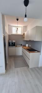a kitchen with white cabinets and a counter top at Apartment sunny view in Ankaran
