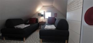 a living room with two chairs and a couch at Domek Na Ustroniu in Sasino