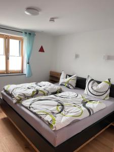 a large bed in a room with a window at Ferienwohnung beim Mane in Schonstett