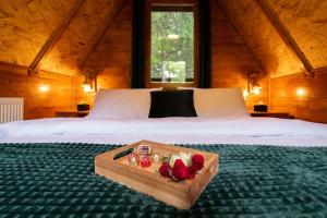 a bedroom with a bed with a tray of roses at Forest Amerika-Bungalovi Milica in Vrbovsko