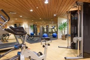 a gym with several exercise equipment in a room at Gasthof Löwen in Schruns