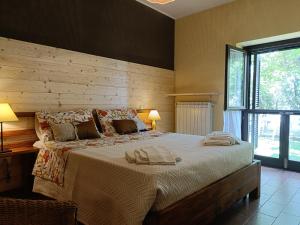 a bedroom with a large bed with two towels on it at Agriturismo Terralieta in Roseto degli Abruzzi