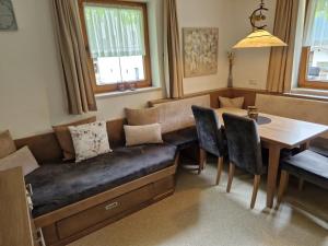 a living room with a couch and a table at Landhaus Schiestl in Ramsau im Zillertal