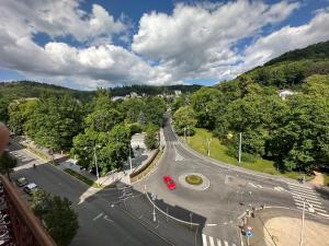 an aerial view of a road with a red car at Sara’s Apartment in Mariánské Lázně