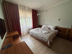 a bedroom with a bed and a large window at Sara’s Apartment in Mariánské Lázně