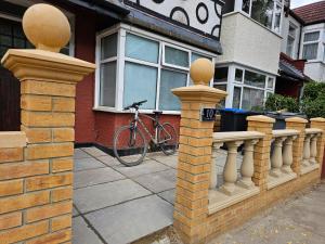 a bike parked in front of a house with a fence at Lovely Rooms London in London