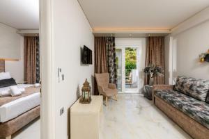 a living room with a couch and a table at Sunny Memories Apartments in Limenas +18 photos