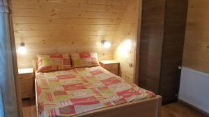 a bedroom with a bed in a wooden room at Domek góralski Zakopane in Zakopane