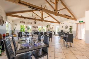 a large dining room with tables and chairs at Camping des Templiers in Le Caylar