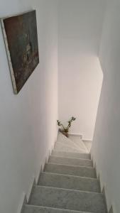 a stairway with a painting on the wall at Villa Possidonia Syros in Ano Syros
