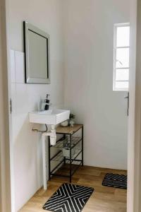 a bathroom with a sink and a mirror at The Studio Apartment - Nottingham Road in Nottingham Road