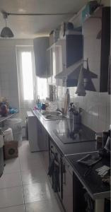 a kitchen with a sink and a counter top at F2 idéalement situé J O in La Courneuve