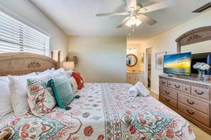 a bedroom with a bed and a ceiling fan at Sea Shell 24 in Clearwater Beach